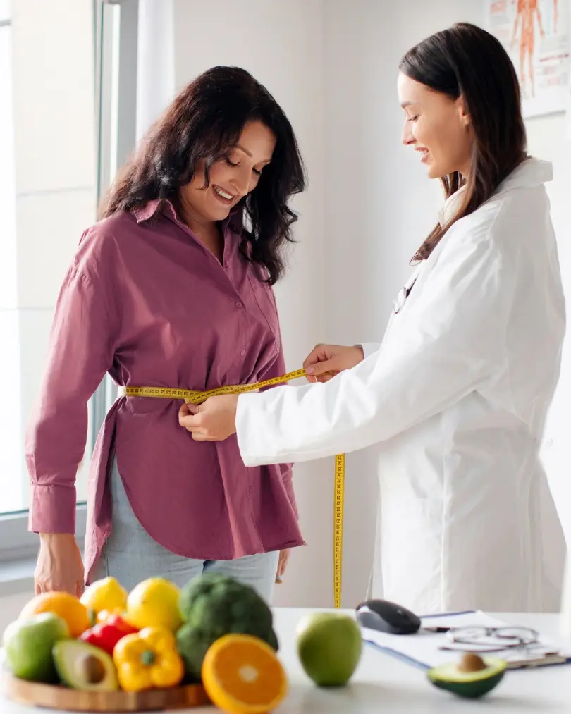 medical-weight-loss-consultation-waist-measurement-evergreen-park-westmont Provider performing a waist measurement during a medical weight loss consultation at CGT Aesthetics in Evergreen Park and Westmont, IL